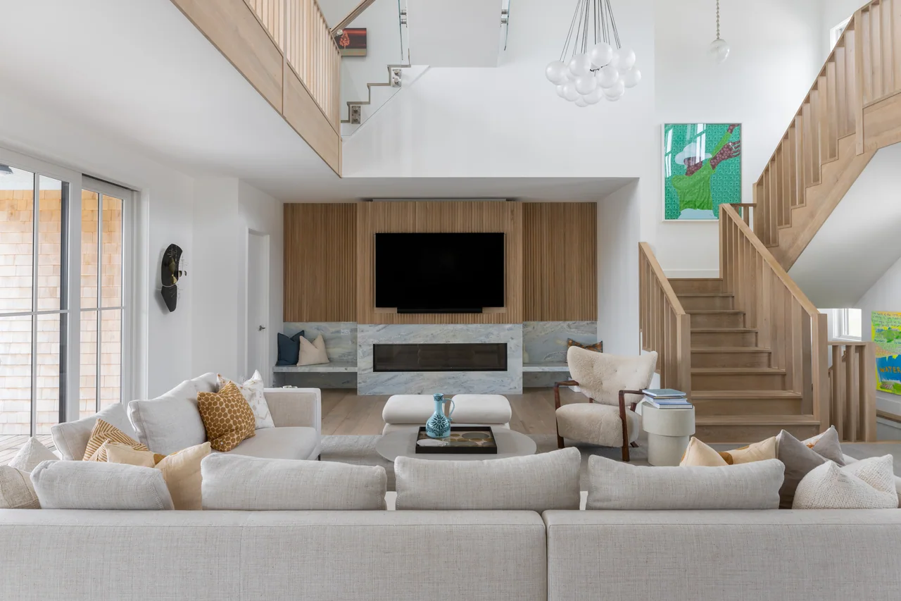 Living room framed by upper galleries and a central fireplace